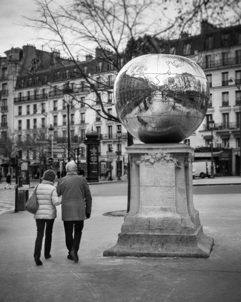 Couple walking at Place de Clichy in Paris.