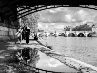 Reflections in a puddle under Pont des Arts in Paris