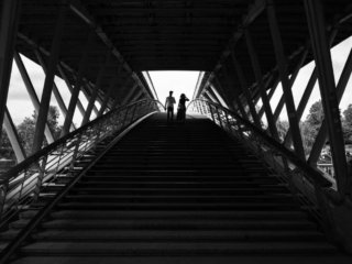 Couple going down the Leopold Sedar-Senghor bridge