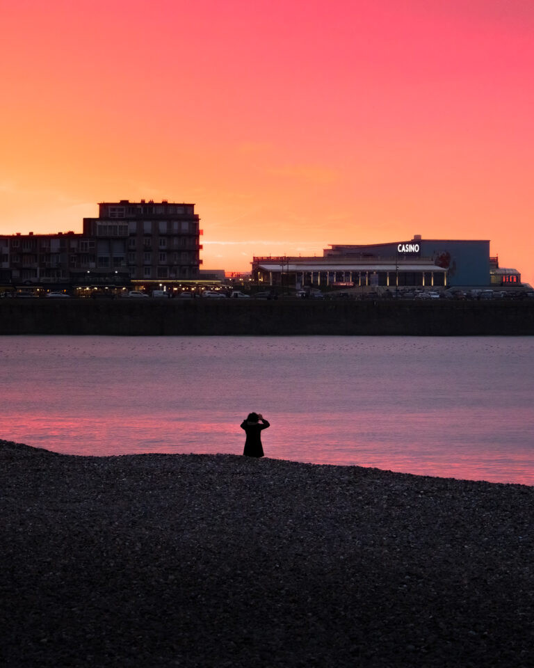 Photographer at Mers-les-Bains beach at sunset.