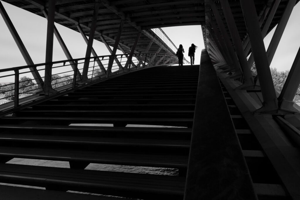 Girls crossing the Leopold Sedar Senghor bridge in Paris