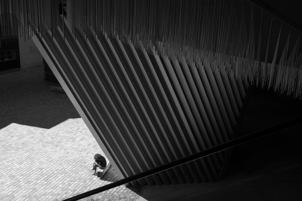 Woman reading on a bench at Philarmonie of Paris
