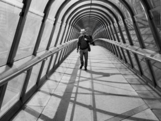 Man with a hat at the Japan bridge in La Defense