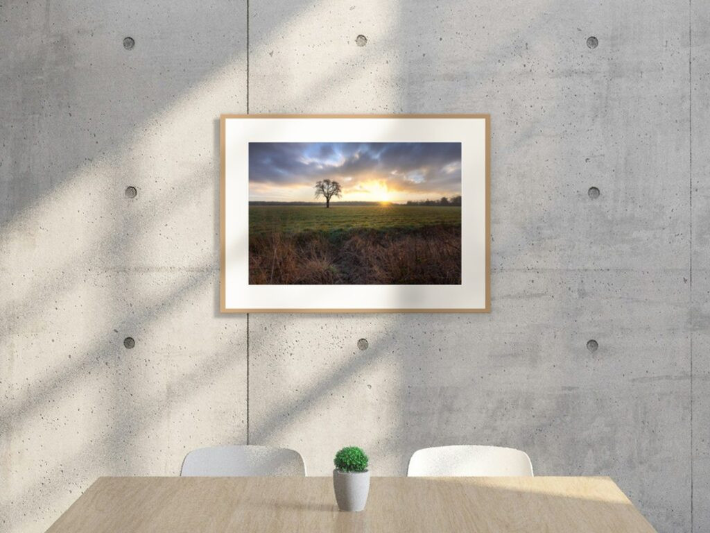 Frozen sunrise at 90 × 60 cm in an oak classic frame with a mount, above a table in a concrete loft (room view)