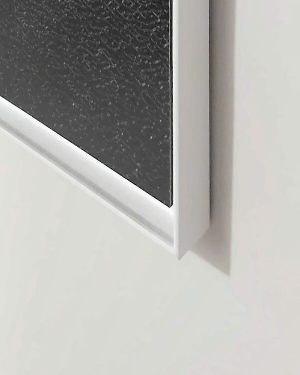 Bottom corner of the white floater frame around the Broken shadow print, seen from the side.