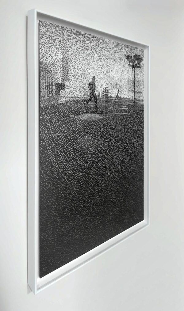 Print of Broken shadow (40 × 60 cm) on Aluminium Dibond in a white floater frame, hanging on a wall, three-quarter view.